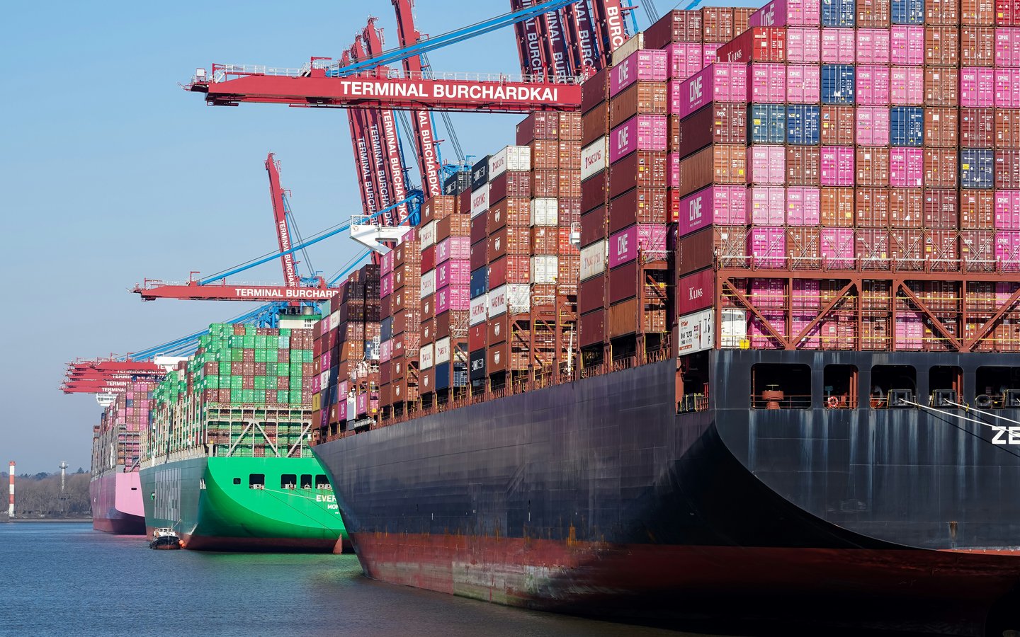 Container vessels alongside a busy international terminal
